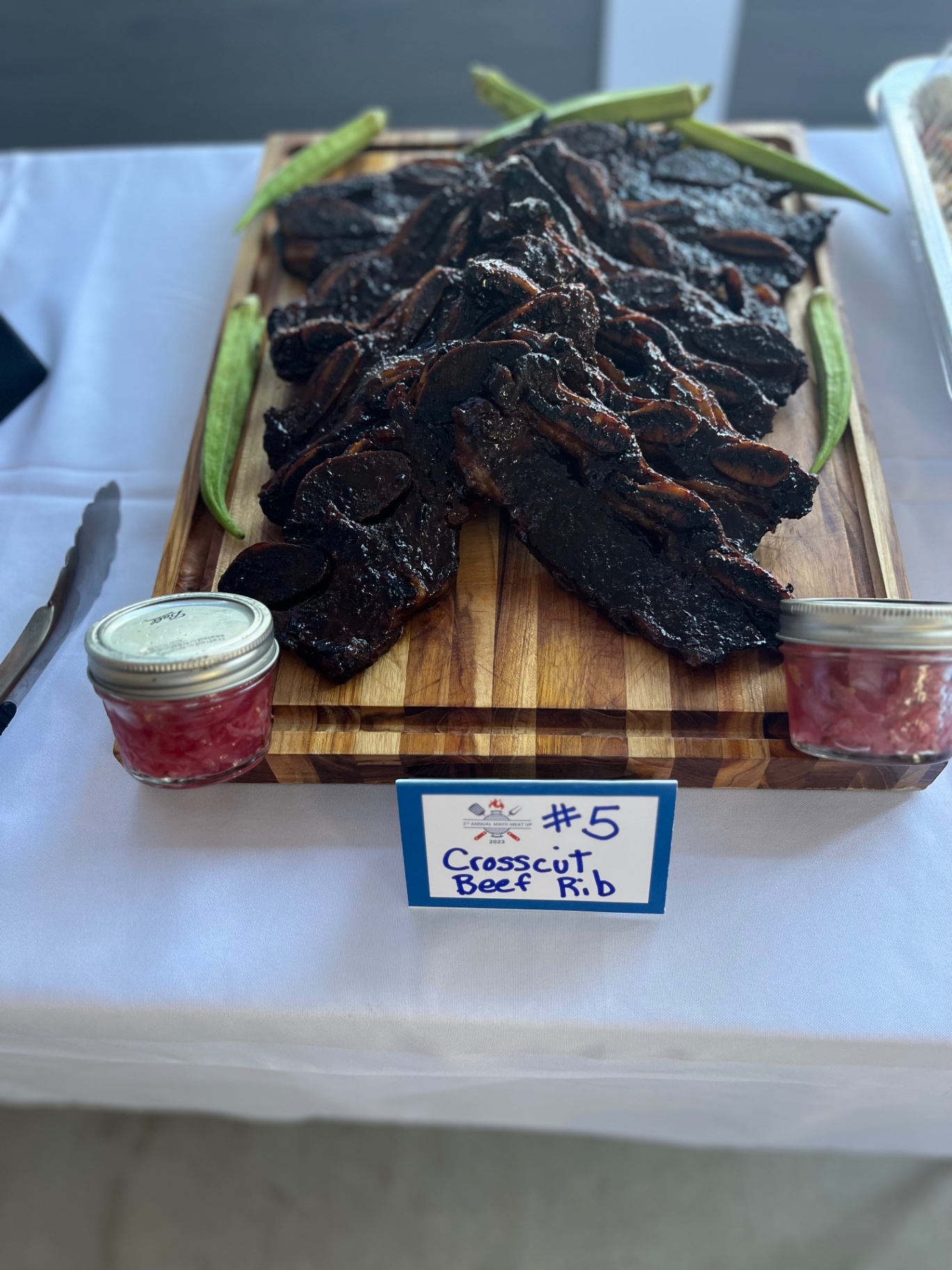 Glazed crosscut beef ribs arranged on a wooden board