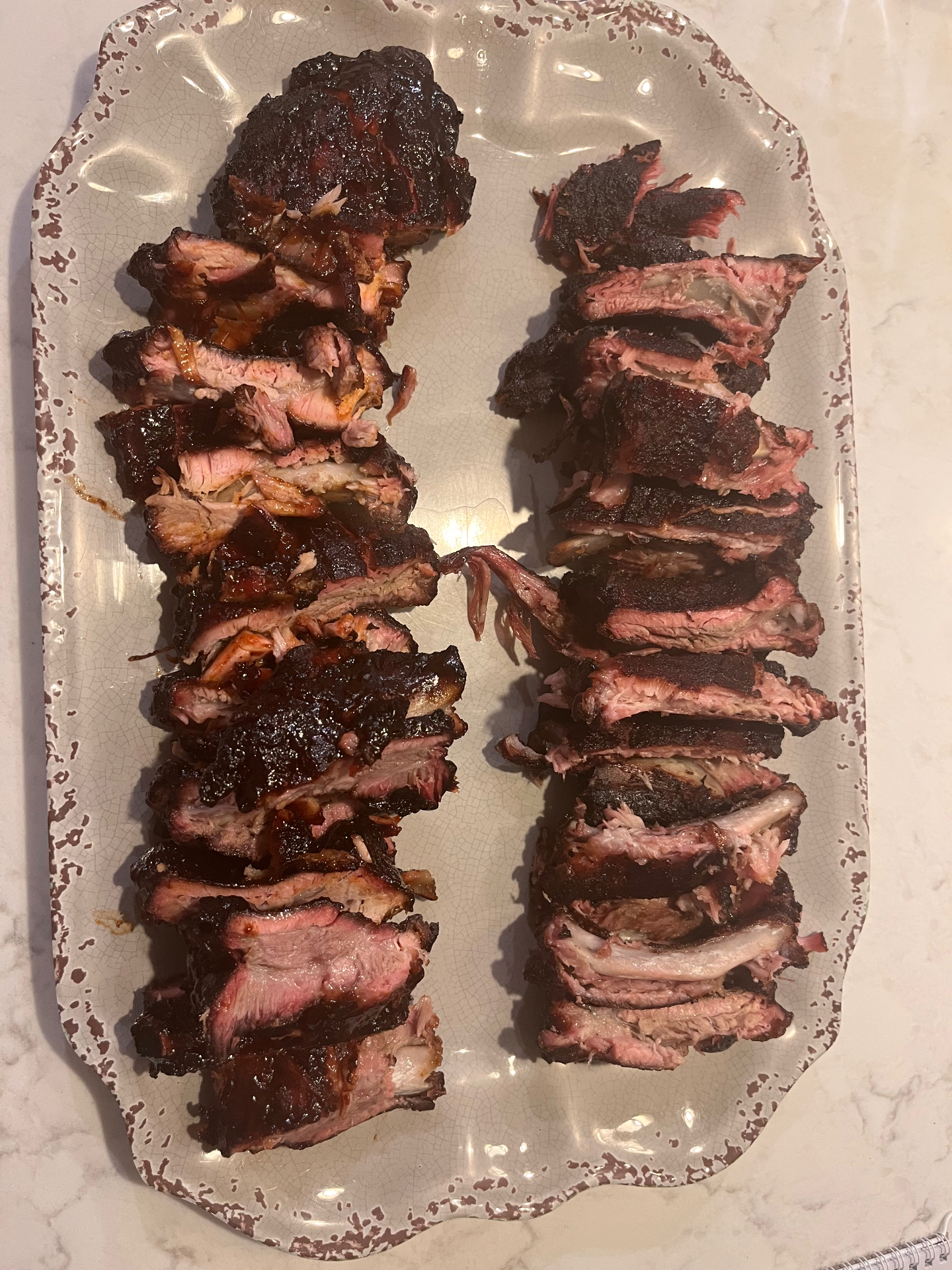 Both racks sliced and plated side by side on a platter — wet on the left, dry on the right