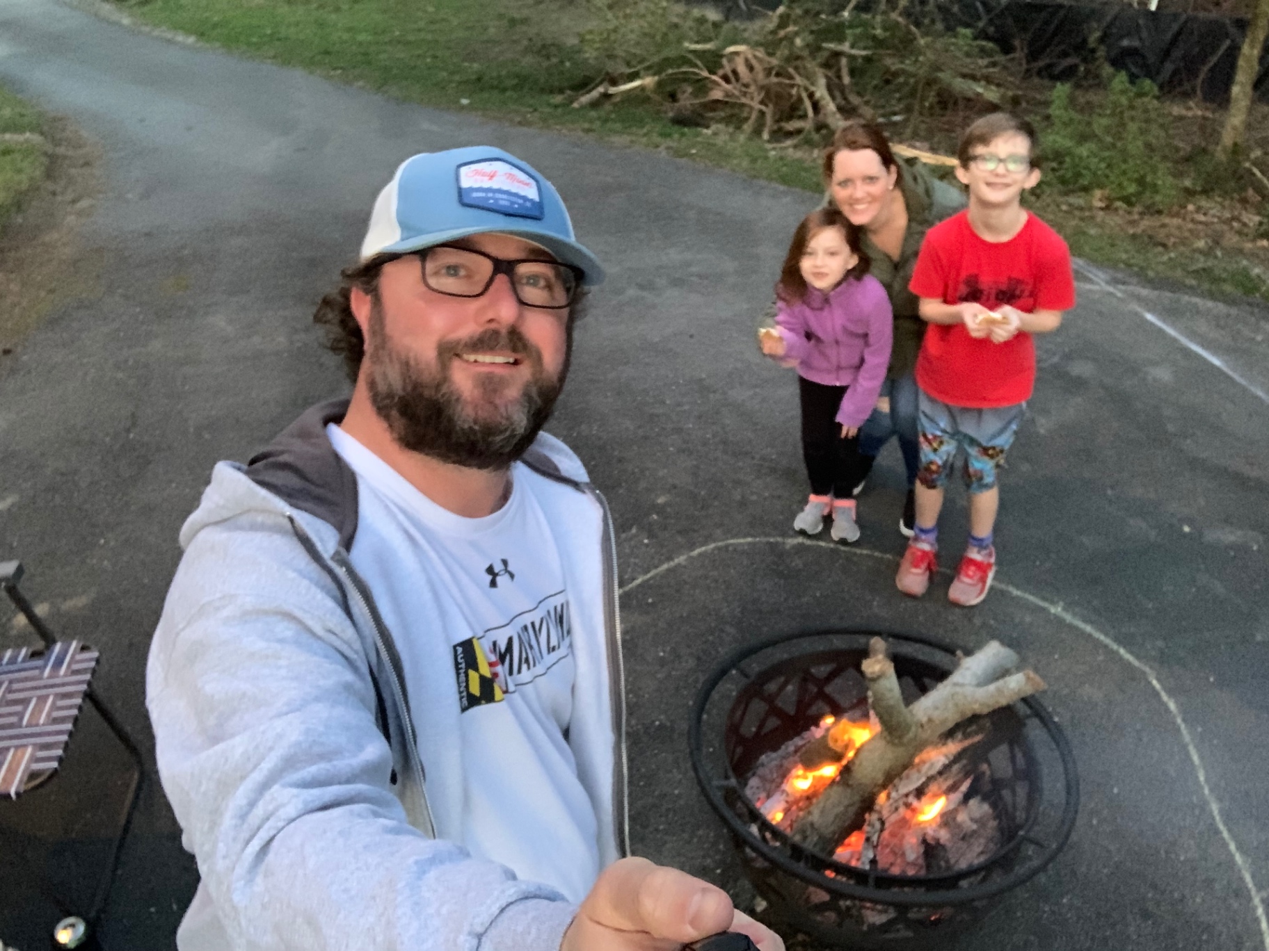 A family gathered around a backyard fire pit